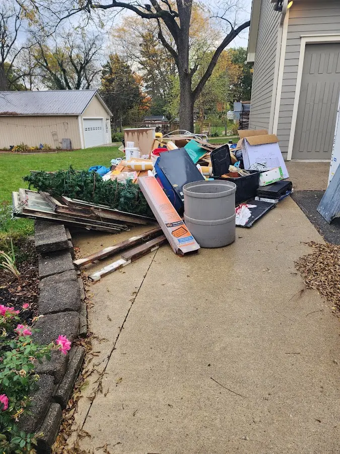 Dumpster being loaded with debris for 10 Yard Dumpster Rental in Frankfort